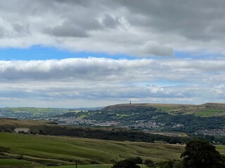 Obraz premium Village in the valley surrounded by hills and countryside. Taken in Lancashire England. 