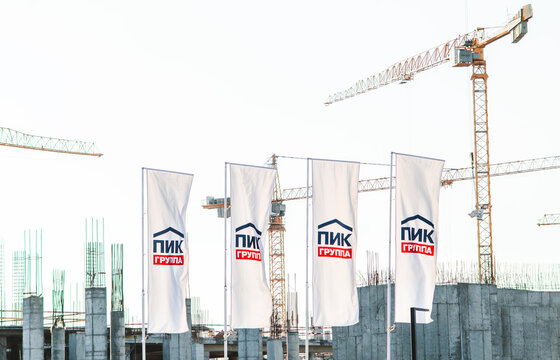 April 4, 2018, Moscow, Russia. Flags depicting the logo of the PIK construction company on the construction site of a multi-storey residential building.