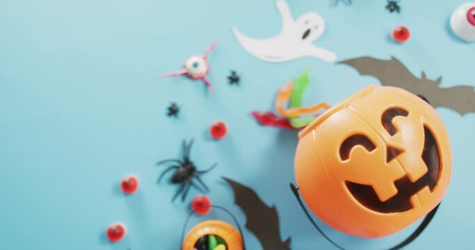 Close up view of multiple halloween toys and candies against blue background