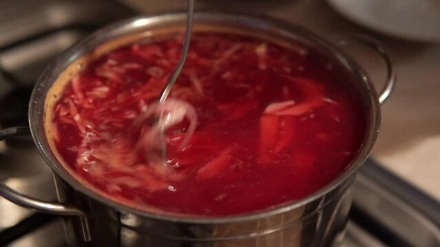 Preparation of a homemade appetizing and tasty borsch made of beetroot, cabbage, potato.