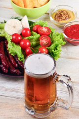 glass of beer on a white table with a snack