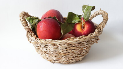 red nectarines in a wicker basket