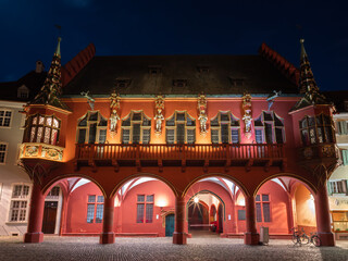 Fototapeta premium Freiburg im Breisgau - April 13, 2022: Historic department store in blue hour - important 14th-century Gothic building with large halls and courtyard for events.