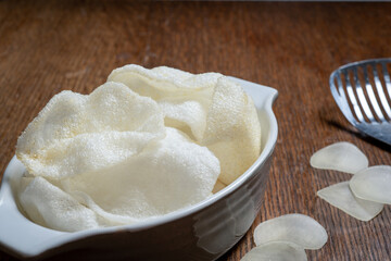 Crispy prawn crackers, deep fried, are served in an oval dish as a starter. 