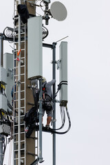 Telekom technicians perform work on a transmission tower