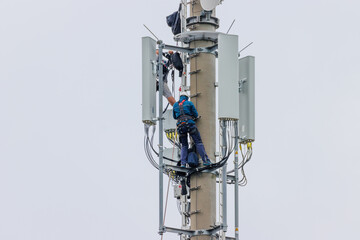 Telekom technicians perform work on a transmission tower