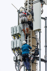 Telekom technicians perform work on a transmission tower