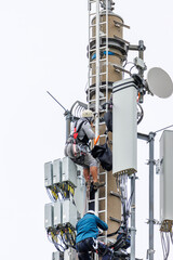 Telekom technicians perform work on a transmission tower