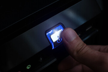 Close up macro shot of the press the power button on computer. Turn on or off PC.