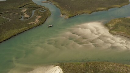 Fishing in a peaceful inlet tidal marsh with sand bar