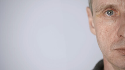 cropped view of middle aged man looking at camera isolated on grey with copy space