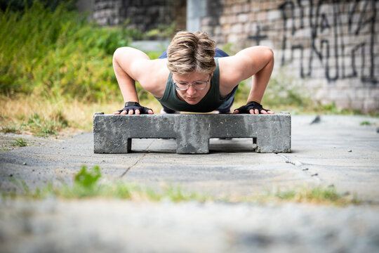 Active 36 Year Old White Woman Planking Under A Bridge Outdoors, Belgium