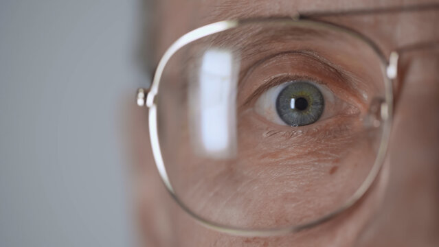 Cropped View Of Middle Aged Man With Blue Eye And Eyeglasses Looking At Camera Isolated On Grey