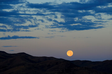Moon Setting or Rising Over Mountains Orange Glow Twilight or Dusk