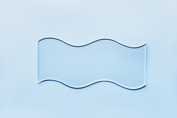 Empty glass wavy slide on blue background. Mockup for cosmetic or scientific product sample