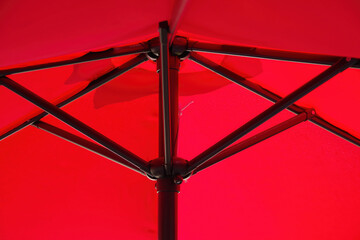 Red patio umbrella parasol seen from below