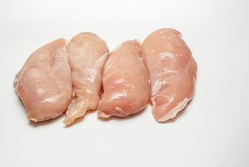 Raw uncooked prepared poultry chicken breasts on a white background