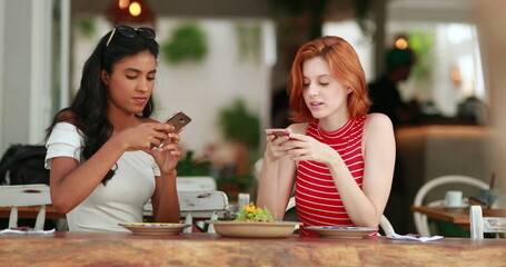 Diverse Two multiracial girls taking photo of food plate meal