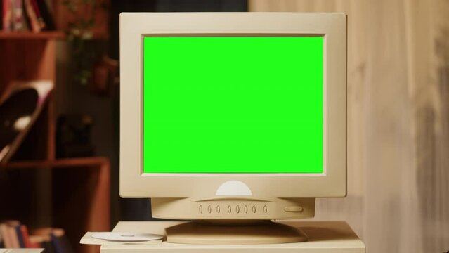 Old computer with green chroma key screen close-up, Desktop PC. Retro room, obsolete technology. 