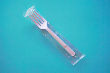 Plastic spoon and fork on table