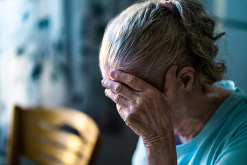 Sad senior old woman. Lonely from loss or sick with headache. Upset patient in retirement home with...