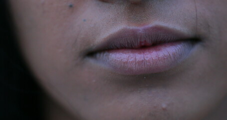 Closeup of black african woman mouth becoming serious