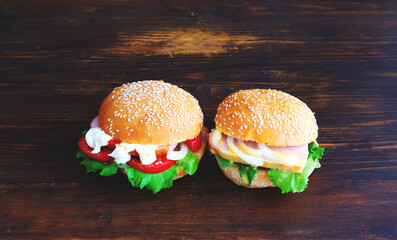 Sandwich with bacon and onion on semmel roll served on texture of old newspaper on rustic background. Creative space for Sandwich Day design. Close-up 