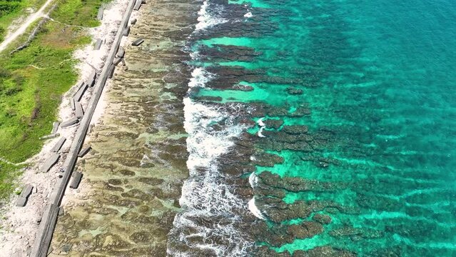 Dream trip to green island. Outdoor adventure travel to beautiful summer beach. Cinematic wild nature aerial 4K. transparent green sea waters. Untouched nature on sunny summer day in Liuqiu Taiwan
