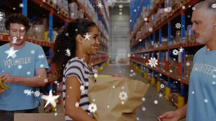 Animation of snow falling over diverse volunteers in warehouse - Powered by Adobe