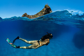 a girl dives in apnea in Mediterranean sea