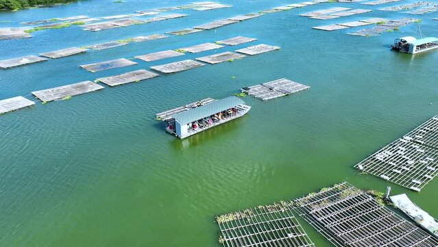 Fishing Boat with Large Catch Oysters Swirling Flock Gulls Aerial View Drone 4K in Oysters farm. Small Ship Floats on Sea Surface Blue Sky Leaving a Path of Sea Foam Water in Tainan, Taiwan Esat Asia