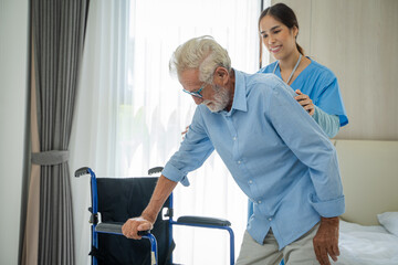 Nurses take care and helping of senior man sitting in a wheelchair,Medical insurance service concept.