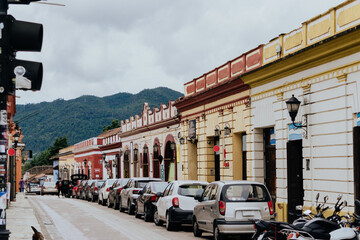 Colorful, small town with local businesses and automobiles 