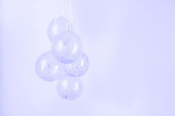Purple confetti clear balloons against a light purple lavender backdrop