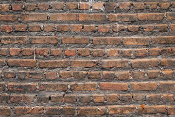 Empty Old Brick Wall Texture. Painted Distressed Wall Surface. Grungy Wide Brickwall. Grunge Red Stonewall Background. Shabby Building Facade With Damaged Plaster. 