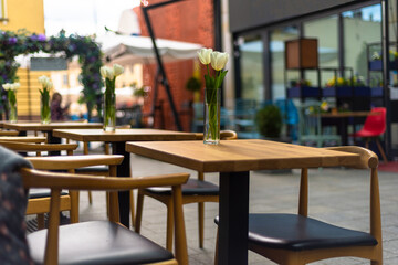Restaurant interior tables near a restaurant. Close up shot of empty cafeteria or restaurant tables with chairs on street