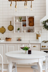 a bottle of red wine on the kitchen table of the bright kitchen
