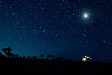 Fototapeta premium The star shines over the manger of christmas of Jesus Christ. panorama