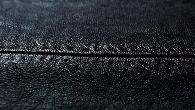 Seam on a dark red brown leather texture. Closeup leather pattern for fashion background