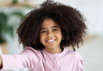 Closeup portrait of happy african american girl taking selfie