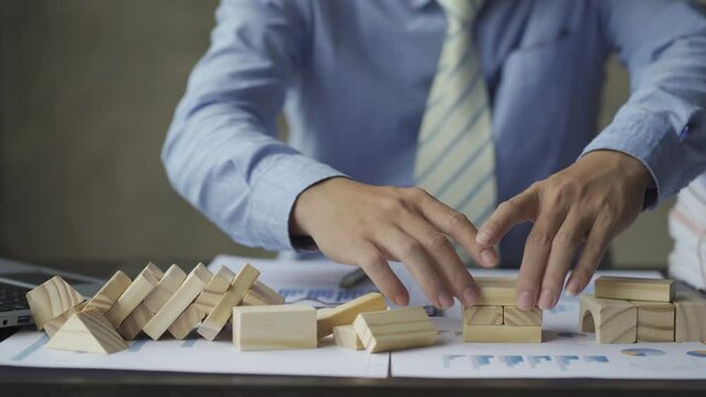 Businessman building a tower with wooden blocks The idea of ​​building a real estate business