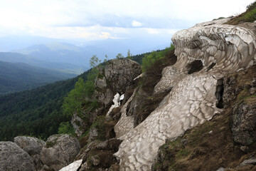 Rock with glacier on Lago-Naki plateau in summer