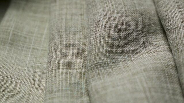 Folds on a natural linen texture background. Abstract thread pattern on a linen fabric
