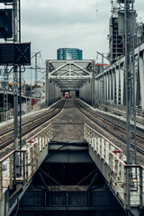 Perspective view of railway track, tunnel and bridge in city landscape. Railway and industrial area of city