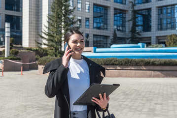 Young woman successful real estate agent making appointment with potential client who is interested for apartment to rent. Rental agency worker selling over the phone home to a buyer.