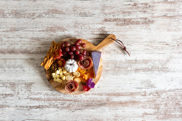 Charcuterie board on white distressed wood background with space for copy - 528759954
