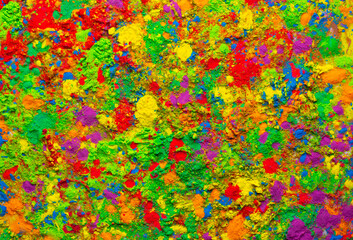 Fototapeta na wymiar Happy Holi. Colorful background of multicolored gulal powder paints. A colorful festival of colored paints made from powder and dust. Celebration of bright colors of Indian tradition.