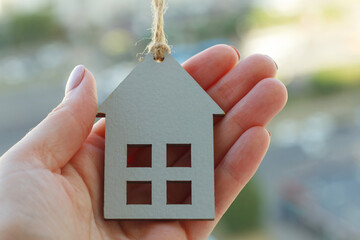 hands holding wooden house, family home, homeless shelter and real estate, housing and mortgage...