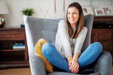 Smiling woman portrait while relaxing at home