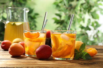 Delicious refreshing drink with apricot on wooden table